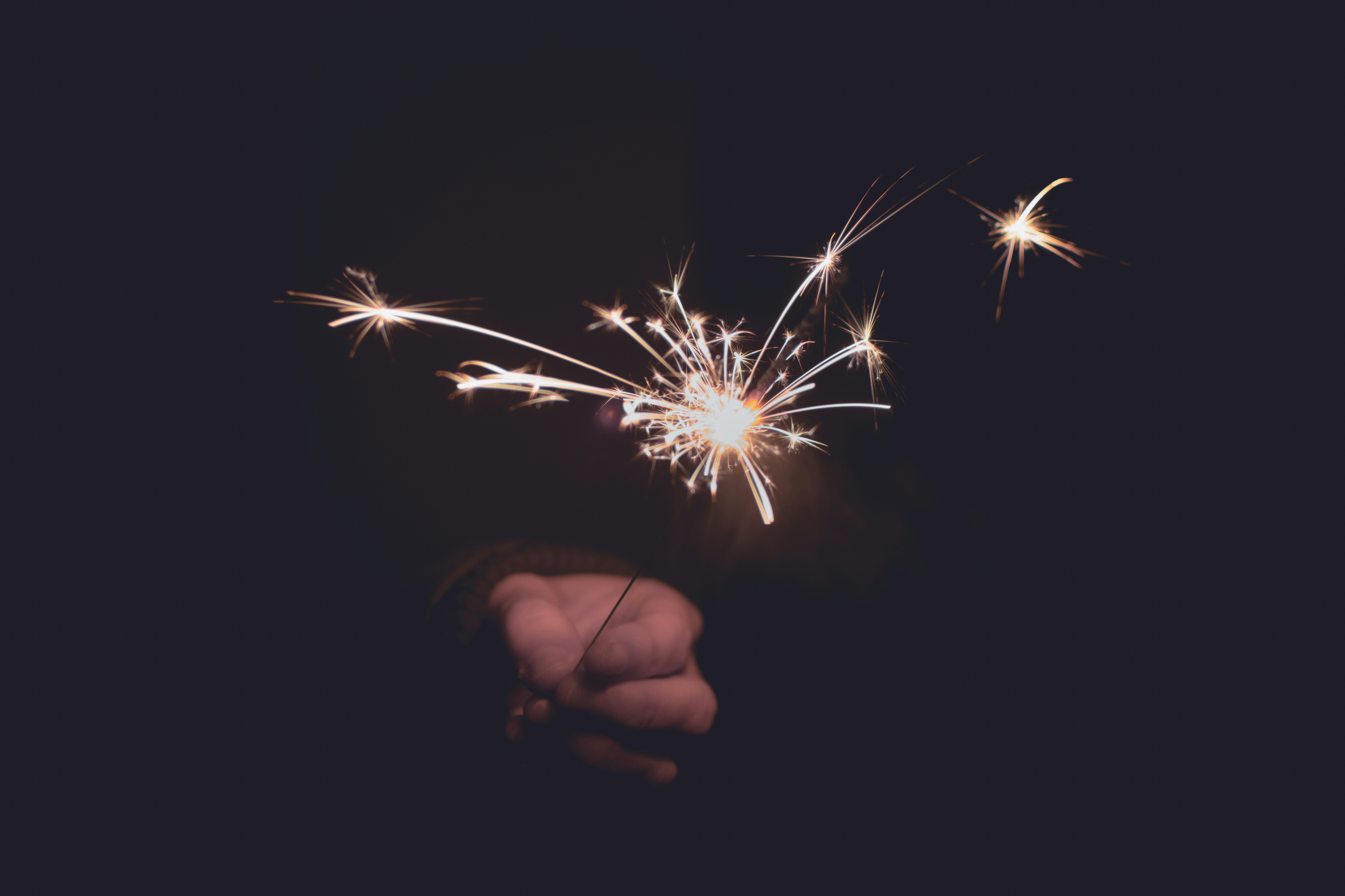 person holding sprinkler firecracker